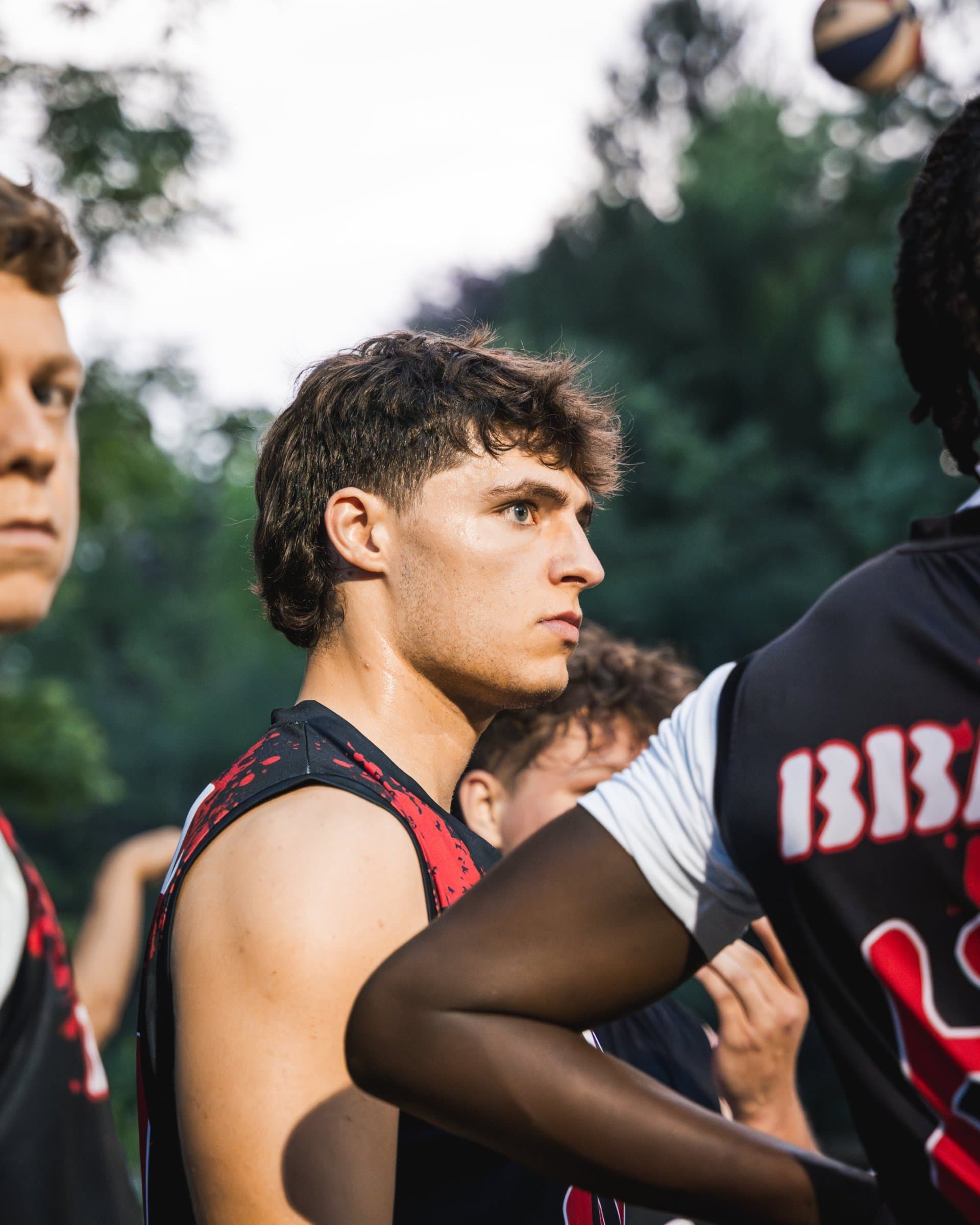 Liam Besecker in the Bullies jersey with his teammates, looking on with a game face